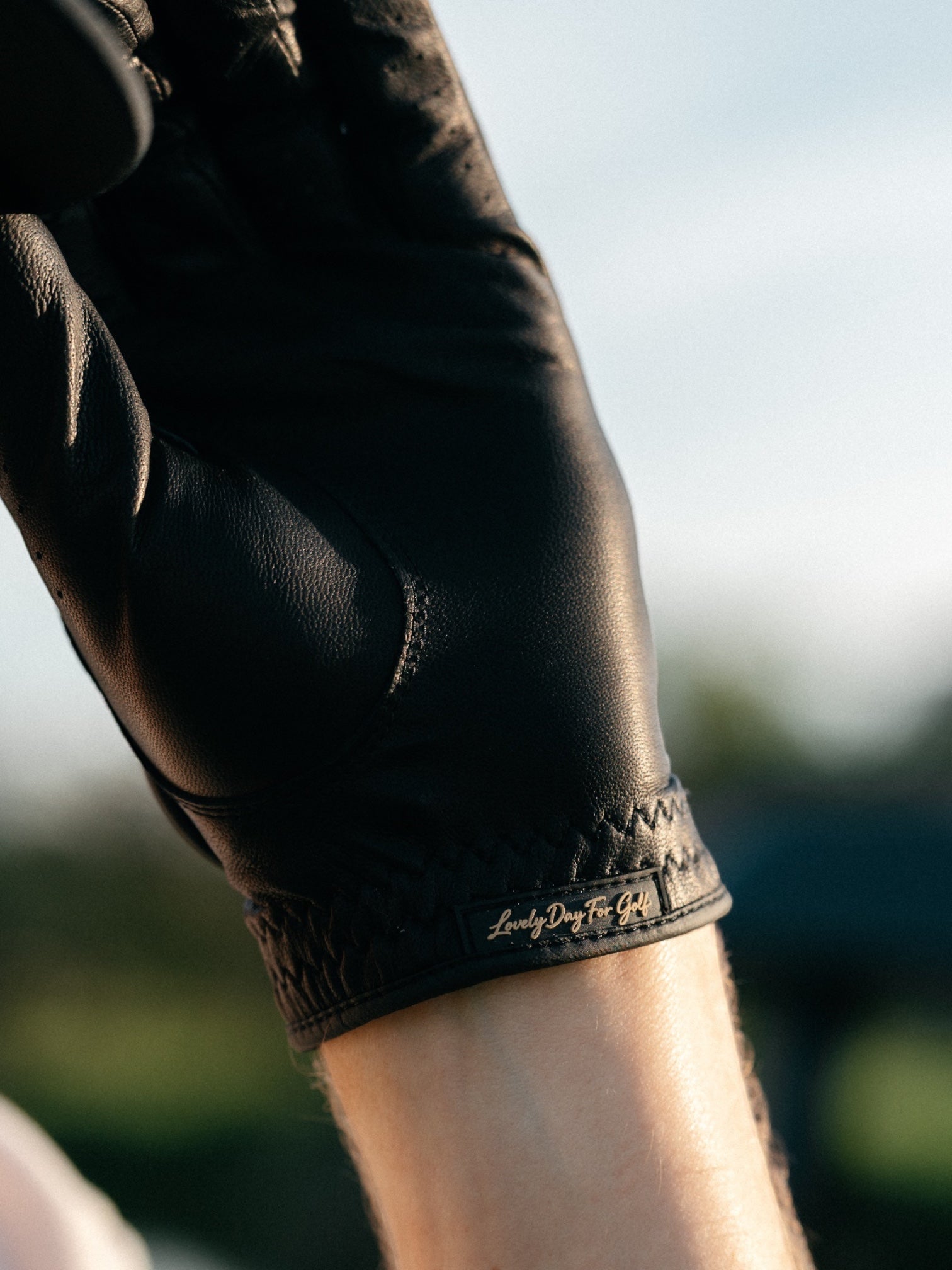 Close detail of the stitched cuff on a Lovely Day For Golf black leather golf glove